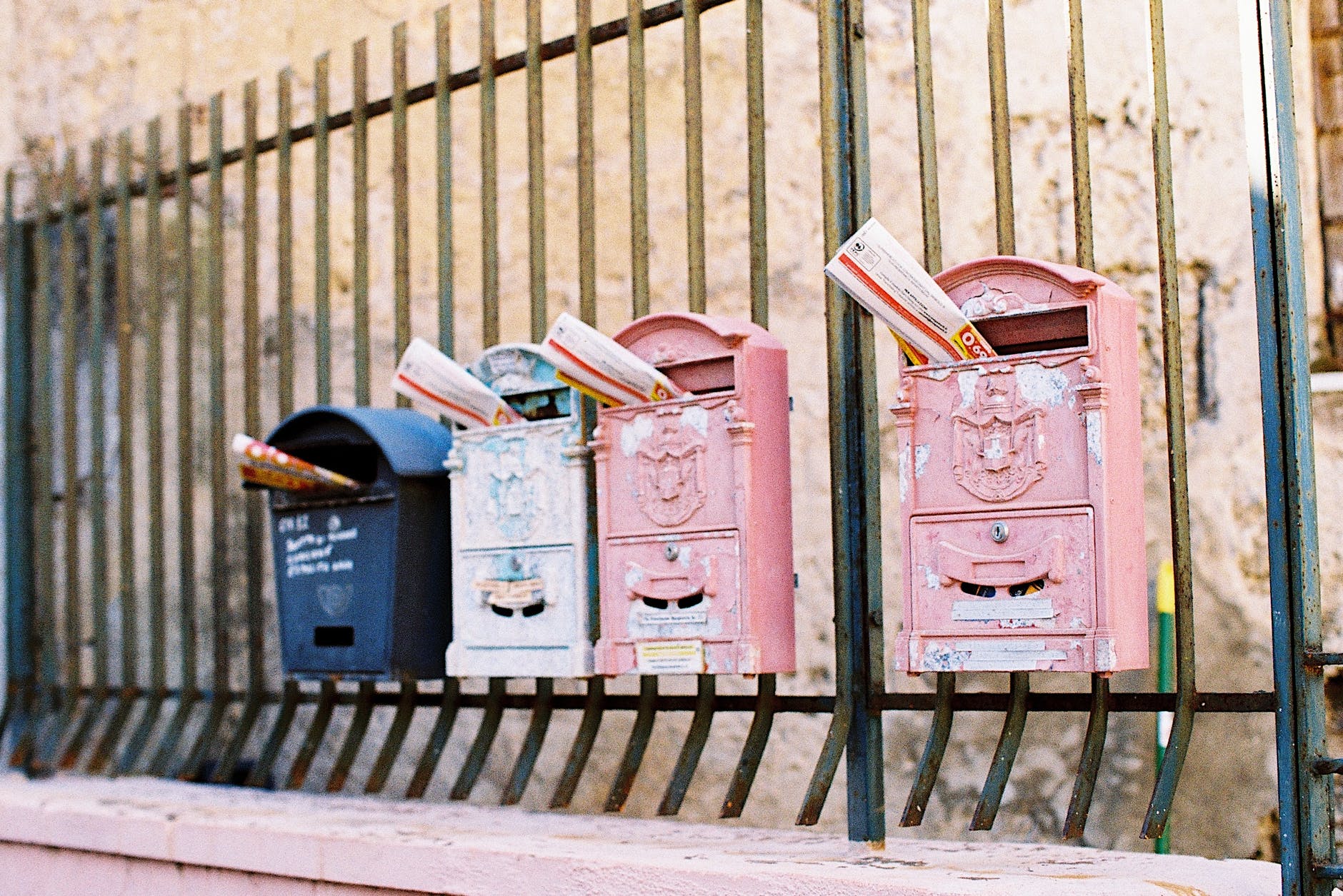 mailboxes on metal fence